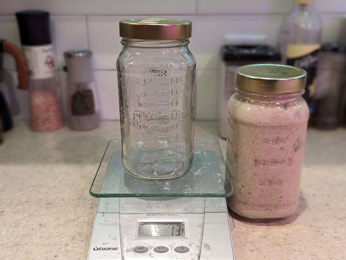 Two mason jars filled with Better Bread courses recipes on a scale.