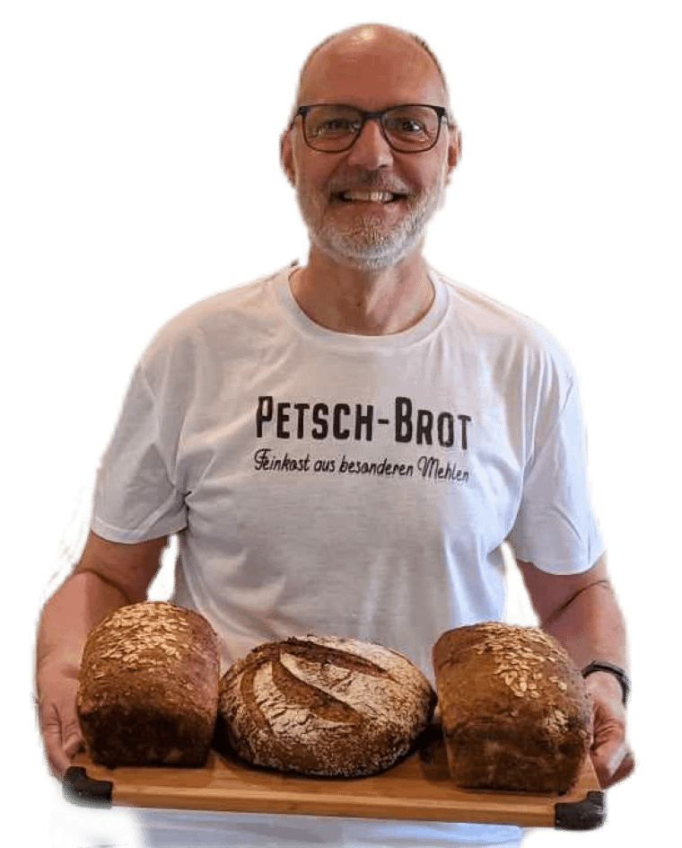 A man holding a tray of bread with the words petsch brot on it.